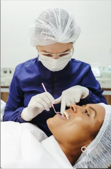 Zahnärztin untersucht Patientin – professionelle Mundhygiene